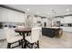 Bright kitchen features white cabinetry, a large island with bar stools and a breakfast table with seating at 10823 Preservation Park Dr, Charlotte, NC 28214