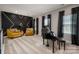 Cozy living room with accent wall, plush armchairs, piano, and bright windows at 10823 Preservation Park Dr, Charlotte, NC 28214