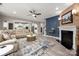 Spacious living room features an open concept, fireplace, views into the kitchen and access to the staircase at 10823 Preservation Park Dr, Charlotte, NC 28214