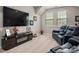 Inviting living room with a TV stand and black leather reclining sofas at 10823 Preservation Park Dr, Charlotte, NC 28214