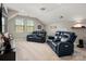 Spacious living room featuring black leather reclining sofas and neutral carpeting at 10823 Preservation Park Dr, Charlotte, NC 28214