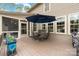 Outdoor patio featuring a dining set with umbrella and grill at 10823 Preservation Park Dr, Charlotte, NC 28214