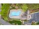 Aerial view of the community pool and clubhouse, showcasing the pool's unique design and surrounding greenery at 10823 Preservation Park Dr, Charlotte, NC 28214