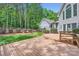 A wooden backyard deck overlooks the yard, and has wooded views and landscaping at 119 Taylor Ct, Mooresville, NC 28117