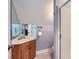 Compact bathroom with a wood vanity, sink, mirror, towel rack, and tiled floor, creating a functional space at 119 Taylor Ct, Mooresville, NC 28117