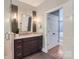 Stylish bathroom featuring a granite vanity, tiled shower, and modern lighting fixtures at 119 Taylor Ct, Mooresville, NC 28117