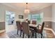 Dining room featuring an elegant chandelier, large windows, and views of the modern kitchen at 119 Taylor Ct, Mooresville, NC 28117
