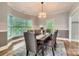 Formal dining room featuring a stylish chandelier, wainscoting, and a large bay window overlooking the landscape at 119 Taylor Ct, Mooresville, NC 28117