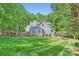 Charming two-story home with a shake roof, a fenced-in yard, and lush landscaping at 119 Taylor Ct, Mooresville, NC 28117