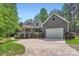 Charming two-story home with a welcoming front porch and a spacious driveway leading to an attached garage at 119 Taylor Ct, Mooresville, NC 28117