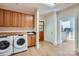 Well-equipped laundry room with ample cabinet space, modern appliances, and hardwood floors at 119 Taylor Ct, Mooresville, NC 28117