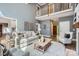 Open-concept living room with a loft view, neutral tones, hardwood floors, and comfortable seating arrangement at 119 Taylor Ct, Mooresville, NC 28117