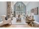 Bright living room with vaulted ceilings, a stone fireplace, and views of the outdoor scenery at 119 Taylor Ct, Mooresville, NC 28117