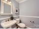 Elegant powder room featuring a pedestal sink, classic fixtures, and stylish decor at 119 Taylor Ct, Mooresville, NC 28117