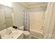 Bathroom featuring a shower-tub combination with white tile and modern fixtures at 121 Silver Fox Ct, Mount Holly, NC 28120
