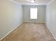 Bright bedroom featuring neutral carpet, freshly painted walls, and a window for natural light at 121 Silver Fox Ct, Mount Holly, NC 28120