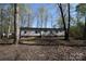 Exterior of home surrounded by many trees and foliage at 121 Silver Fox Ct, Mount Holly, NC 28120