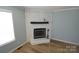 Close-up view of the living room fireplace with brick surround and black mantel at 121 Silver Fox Ct, Mount Holly, NC 28120