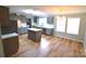 This bright, updated kitchen features an island, stainless appliances, new countertops, and ample room at 121 Silver Fox Ct, Mount Holly, NC 28120