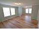 Spacious living room with plenty of natural light from multiple windows and hardwood floors at 121 Silver Fox Ct, Mount Holly, NC 28120