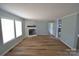 Bright living room features hardwood floors, fireplace, and a view into the kitchen at 121 Silver Fox Ct, Mount Holly, NC 28120