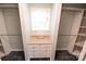 Walk-in closet with custom built-in shelves and a window at 121 Silver Fox Ct, Mount Holly, NC 28120