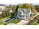 Aerial view of a two-story home showcasing a pool, manicured yard, and a brick driveway at 1212 Queens Rd, Charlotte, NC 28207