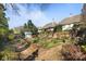Lush backyard garden showcasing established plants, trees, brick wall, and charming shed at 1212 Queens Rd, Charlotte, NC 28207