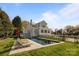 Resort-style backyard with a rectangular pool, lounge chairs, and lush green lawn, perfect for relaxation at 1212 Queens Rd, Charlotte, NC 28207