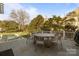 Outdoor patio featuring a dining table set with a view of the backyard, pool, and well-manicured landscaping at 1212 Queens Rd, Charlotte, NC 28207