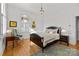 Bedroom featuring hardwood floors, a decorative rug, and stylish furnishings at 1212 Queens Rd, Charlotte, NC 28207