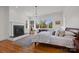 Bright bedroom with a fireplace, hardwood floors, and a large window overlooking the yard at 1212 Queens Rd, Charlotte, NC 28207