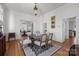 Formal dining area with hardwood floors, a dark wood table, and neutral-toned chairs at 1212 Queens Rd, Charlotte, NC 28207