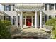 Inviting front entrance with a red door framed by white columns and twin benches at 1212 Queens Rd, Charlotte, NC 28207