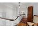 Second floor hallway featuring hardwood floors, a vintage area rug, and natural light at 1212 Queens Rd, Charlotte, NC 28207
