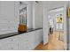 Butler's pantry offers ample storage with custom cabinetry and adjacent access to the living room at 1212 Queens Rd, Charlotte, NC 28207