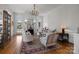 Cozy living room featuring hardwood floors, elegant furnishings, and a fireplace at 1212 Queens Rd, Charlotte, NC 28207