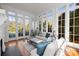Bright and airy living room with hardwood floors and multiple windows at 1212 Queens Rd, Charlotte, NC 28207