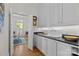 Charming butler's pantry with white cabinets, black countertops, and a farmhouse sink at 1212 Queens Rd, Charlotte, NC 28207