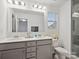 Bright bathroom with dual sinks and large framed mirror at 124 Benford Dr, Troutman, NC 28166