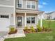 Charming home featuring a well-maintained front yard and an inviting front porch with stone accents at 124 Benford Dr, Troutman, NC 28166