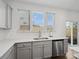 Bright kitchen with white countertops, stainless steel appliances, and large window at 124 Benford Dr, Troutman, NC 28166