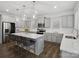 Modern kitchen featuring gray cabinets, stainless steel appliances, hardwood floors and a spacious island with seating at 124 Benford Dr, Troutman, NC 28166