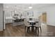 Bright open kitchen with island seating, pendant lights, stainless appliances, and a dining area at 124 Benford Dr, Troutman, NC 28166