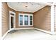 Cozy covered back porch with warm lighting, offering a great outdoor living space at 12424 Bradford Park Dr, Davidson, NC 28036