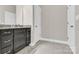 Clean bathroom with a granite countertop vanity and tile floors for a classic appeal at 12424 Bradford Park Dr, Davidson, NC 28036