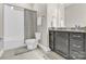 Well-maintained bathroom featuring tiled floors, shower-tub combo, and a dark vanity at 12424 Bradford Park Dr, Davidson, NC 28036
