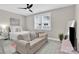 Relaxing bedroom featuring soft carpeting, ample natural light, and a comfortable sitting area at 12424 Bradford Park Dr, Davidson, NC 28036