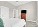 Bedroom featuring a dresser with a television and a ceiling fan at 12424 Bradford Park Dr, Davidson, NC 28036