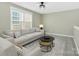 Comfortable bonus room featuring a cozy sofa and chairs, perfect for relaxation and entertainment at 12424 Bradford Park Dr, Davidson, NC 28036